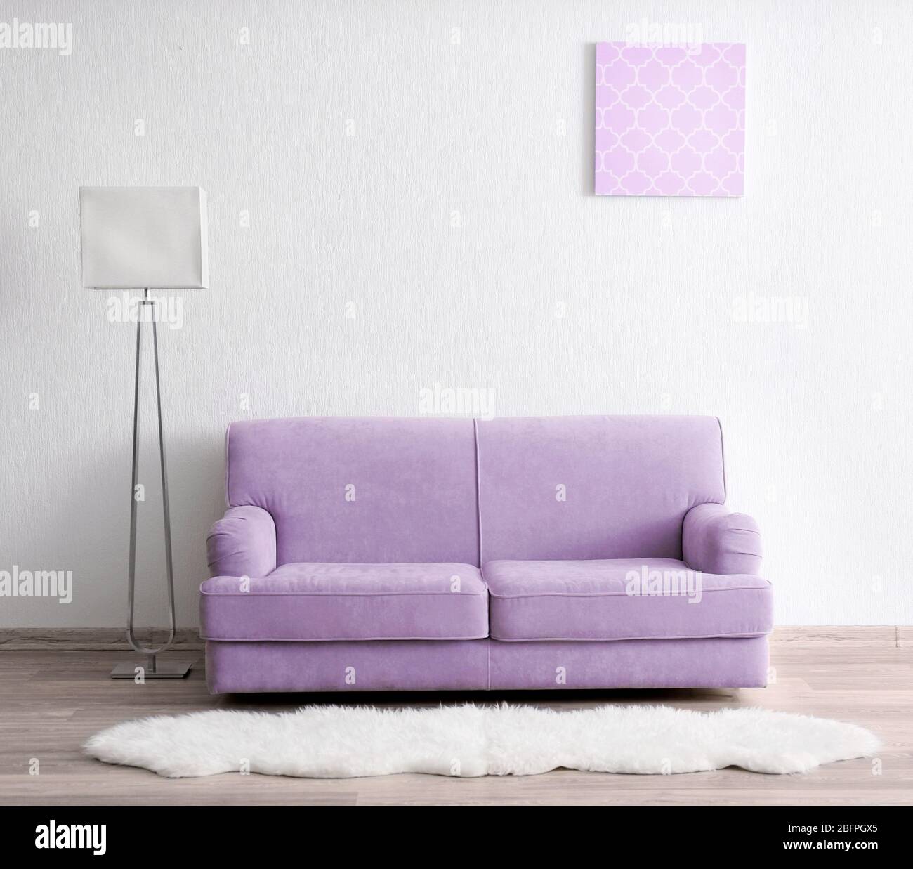 Lilac color accent in modern interior. Comfortable couch and lamp in living  room Stock Photo - Alamy