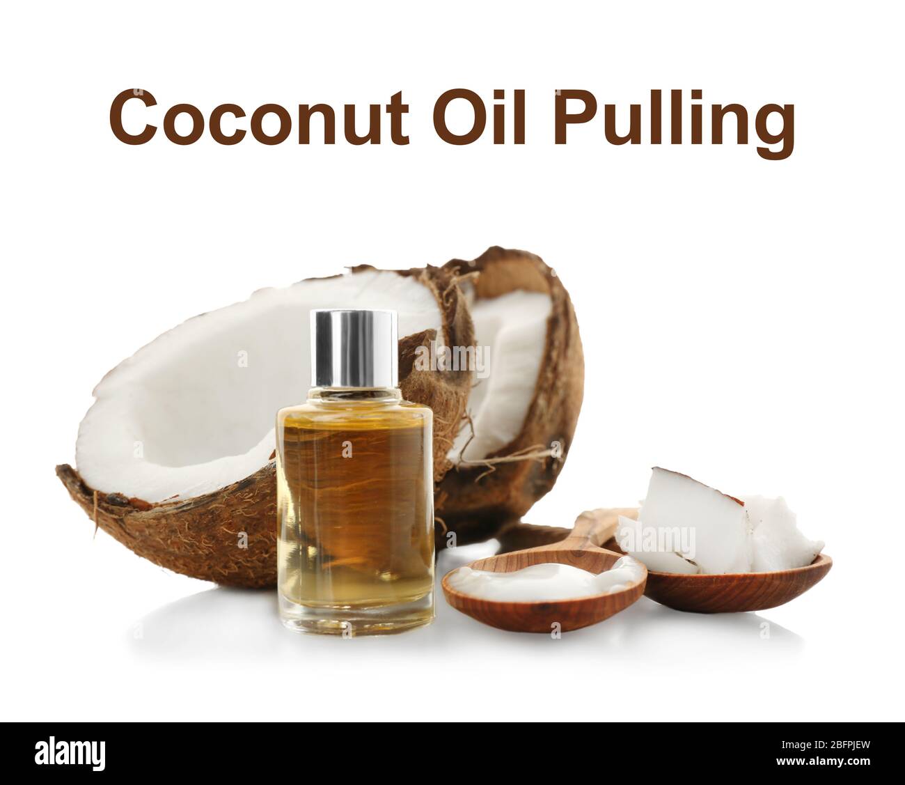 Nut and bottle of coconut oil pulling on white background Stock Photo