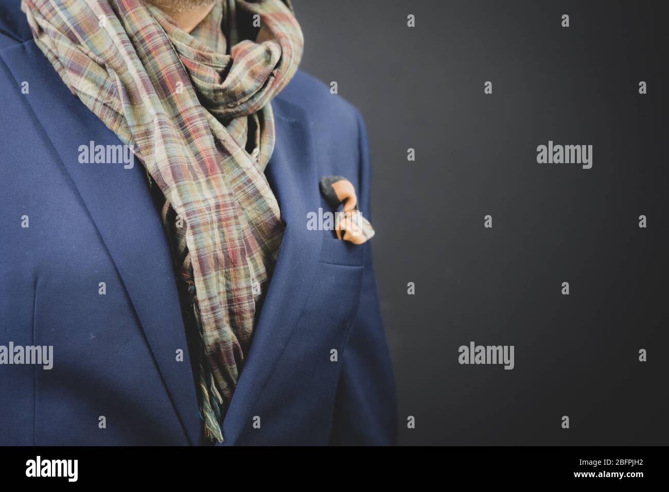 Stylish man smartly dressed in a scarf and suit. Stock Photo