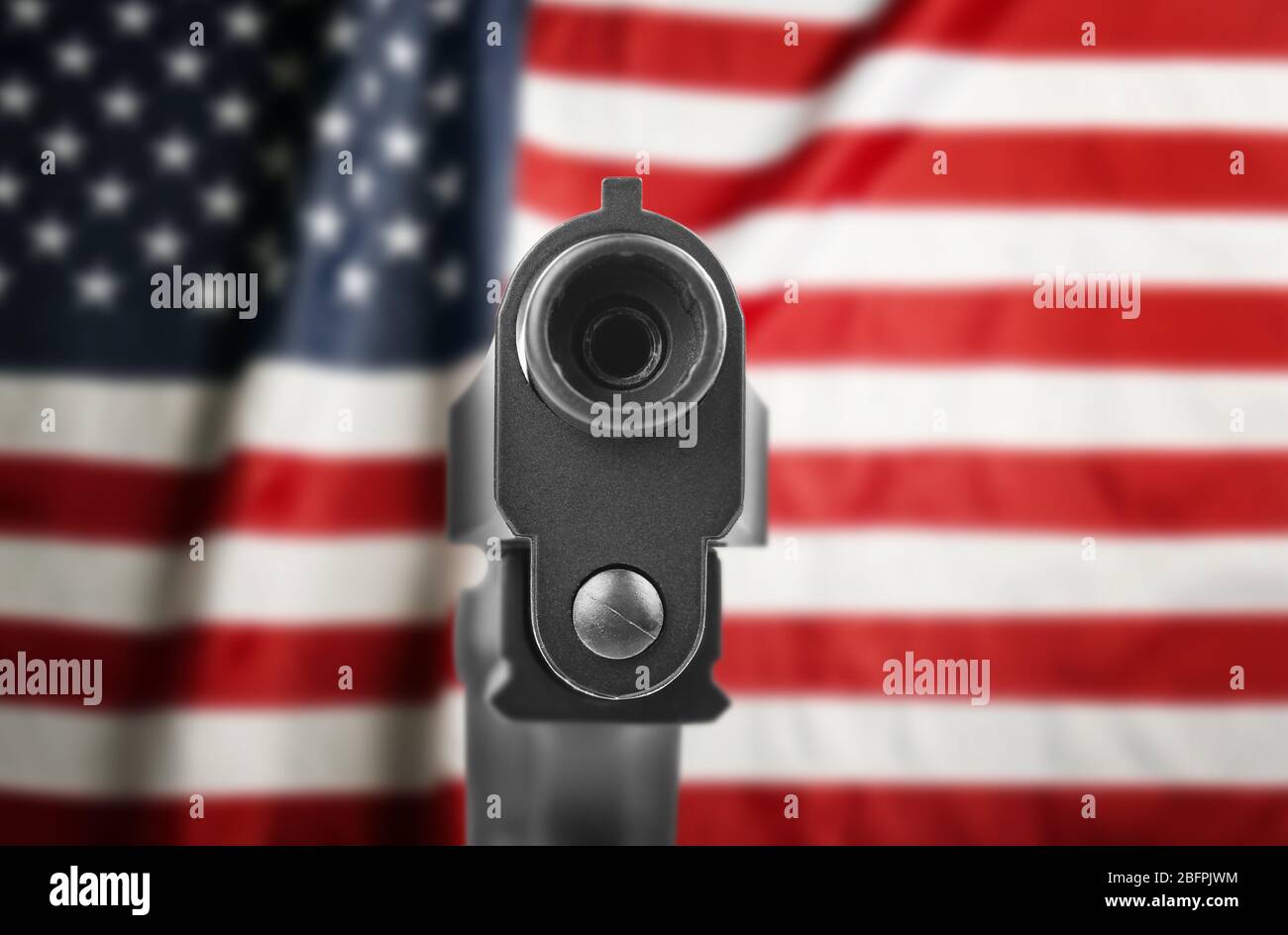 Firearm and American flag on background. Gun control concept Stock