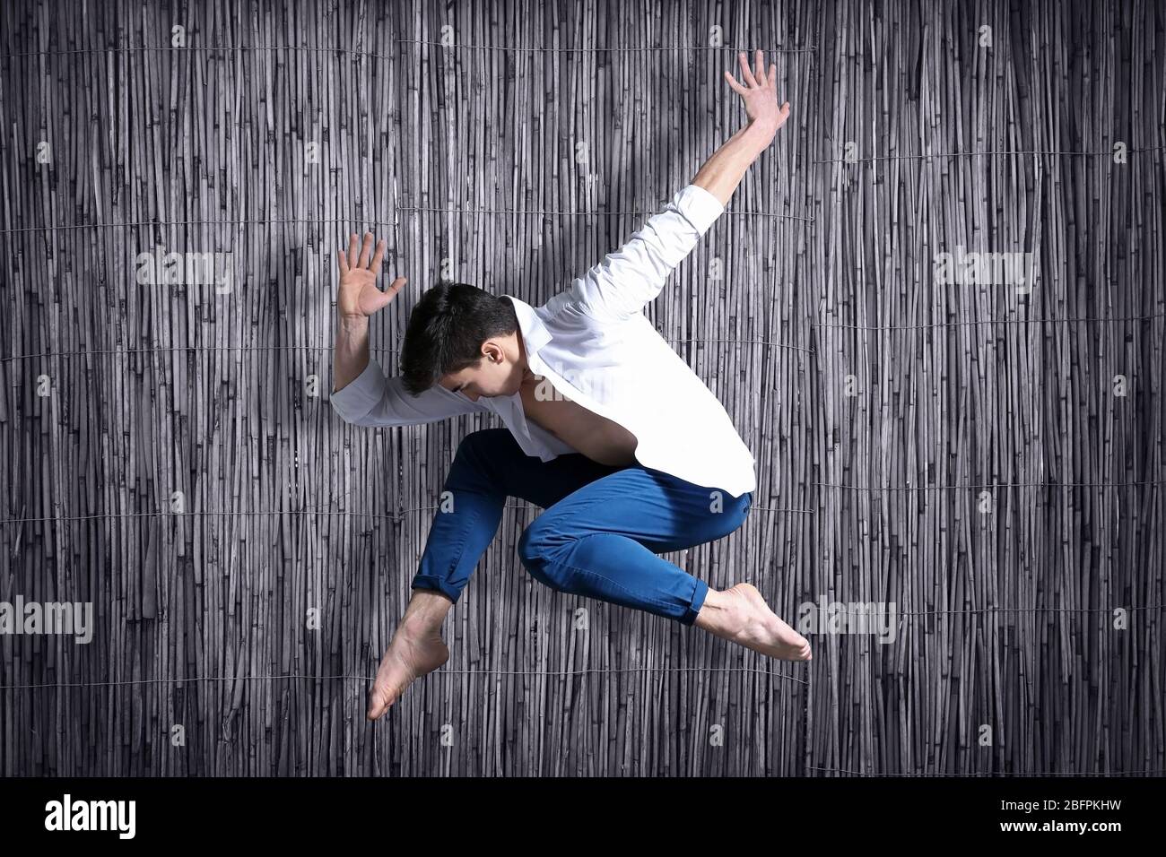Young dancer on bamboo background Stock Photo