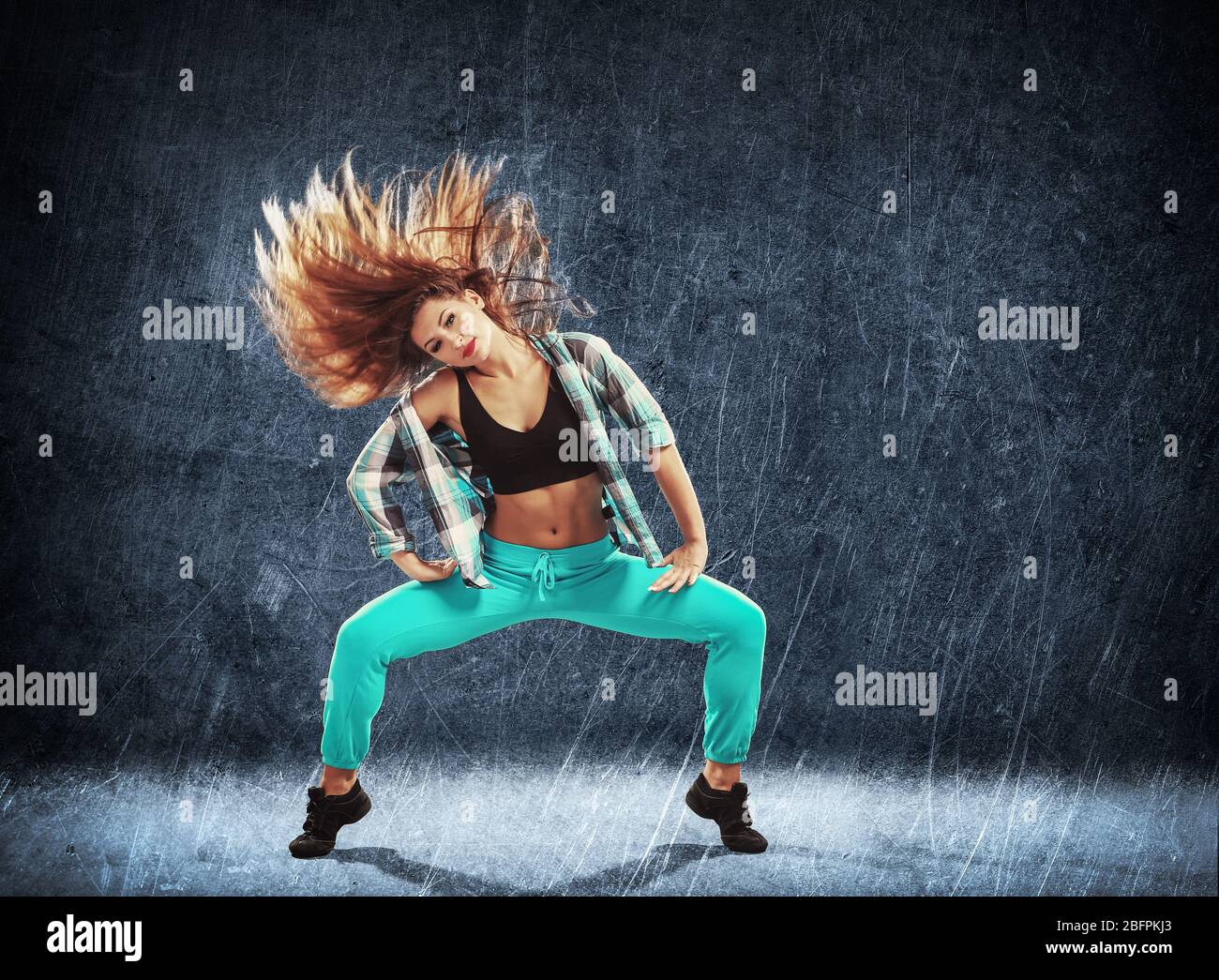 Young hip-hop dancer on grunge background Stock Photo - Alamy
