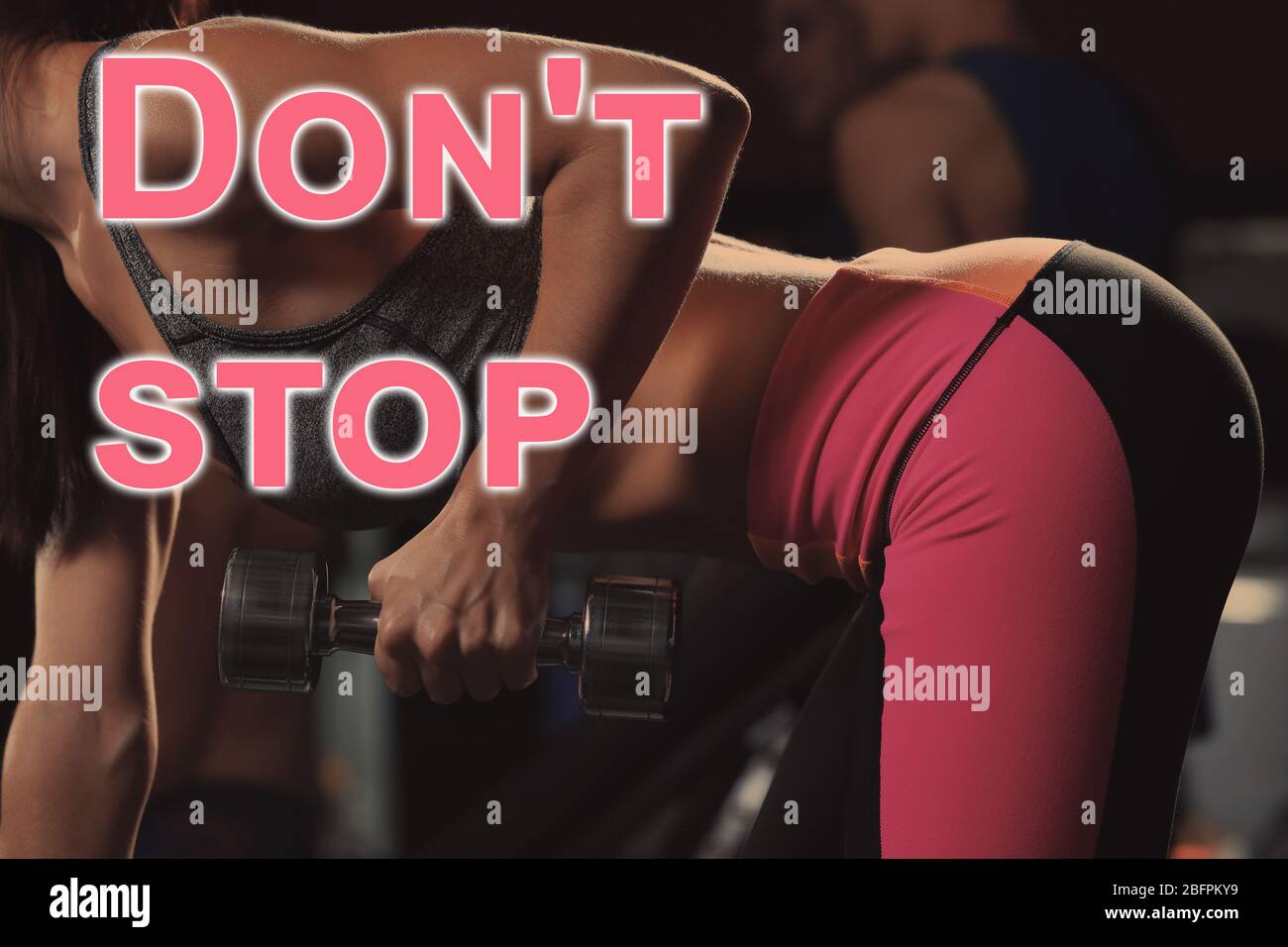 Fitness quotes. Text DON'T STOP and young woman training with dumbbell on background Stock Photo