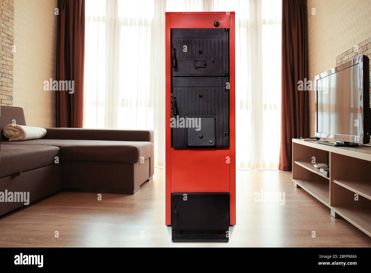 Energy savings concept. Solid fuel boiler in living room Stock Photo