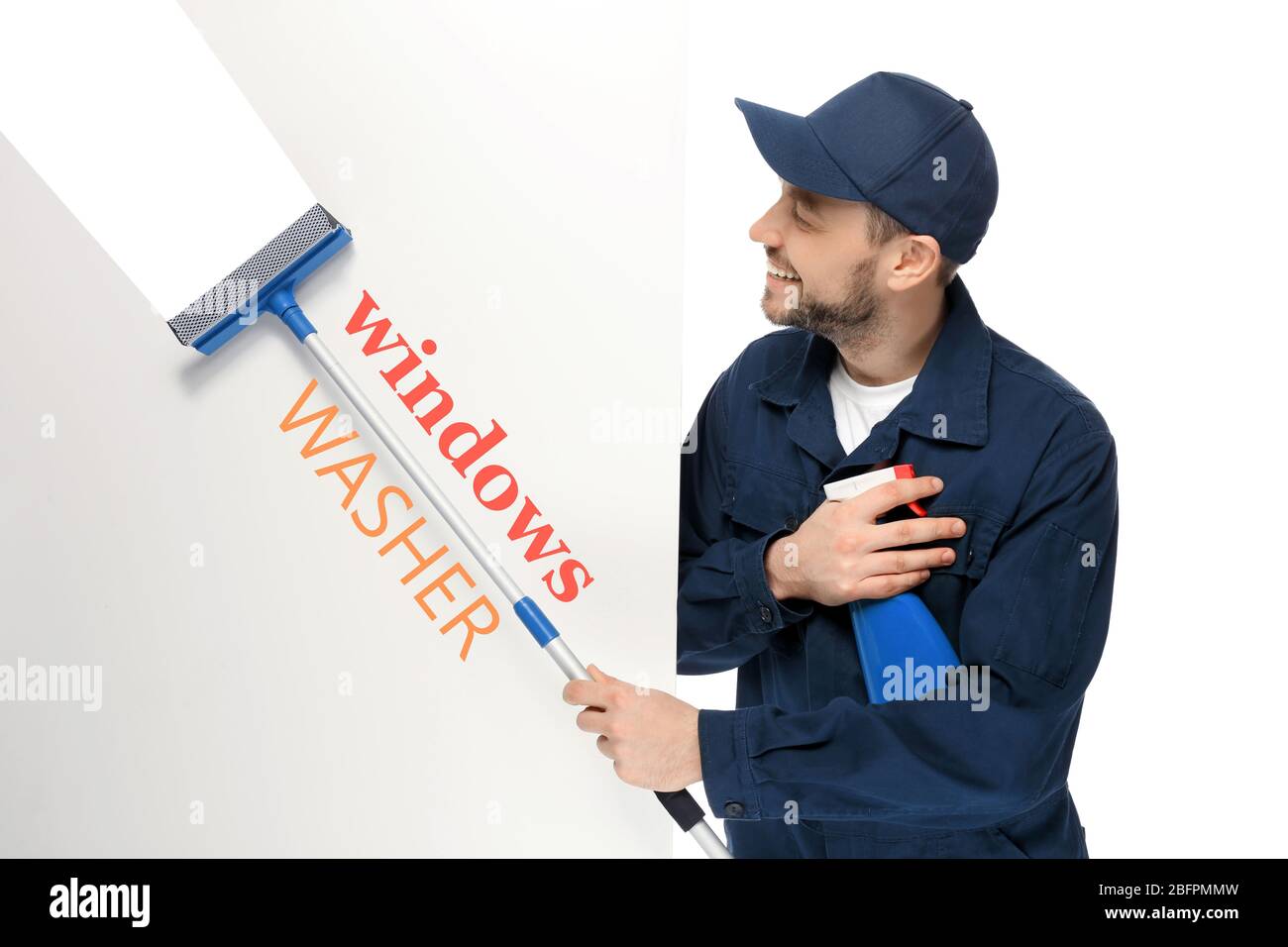 Young window cleaner with squeegee and poster on white background Stock Photo