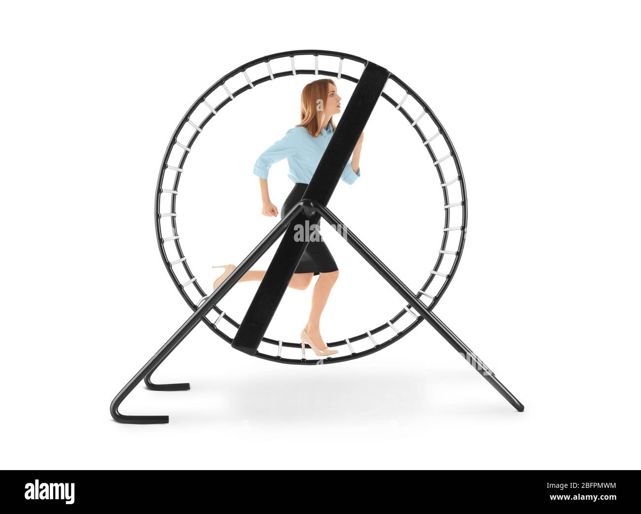 Young woman running in wheel on white background. Business rat race concept Stock Photo