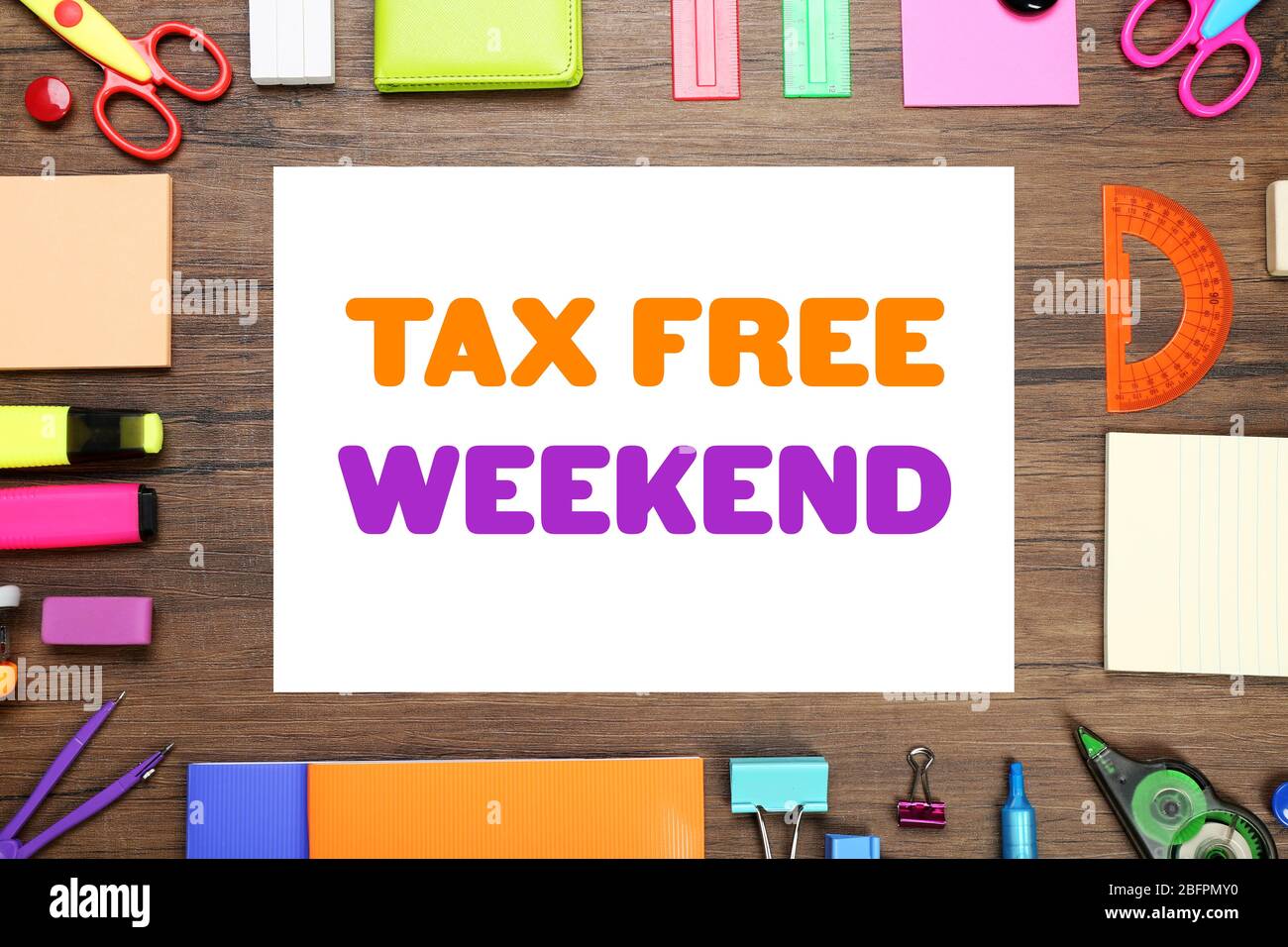 Office supplies and paper with text TAX FREE WEEKEND on wooden background Stock Photo