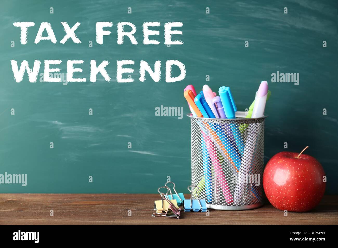 School supplies with text TAX FREE WEEKEND and blackboard on background