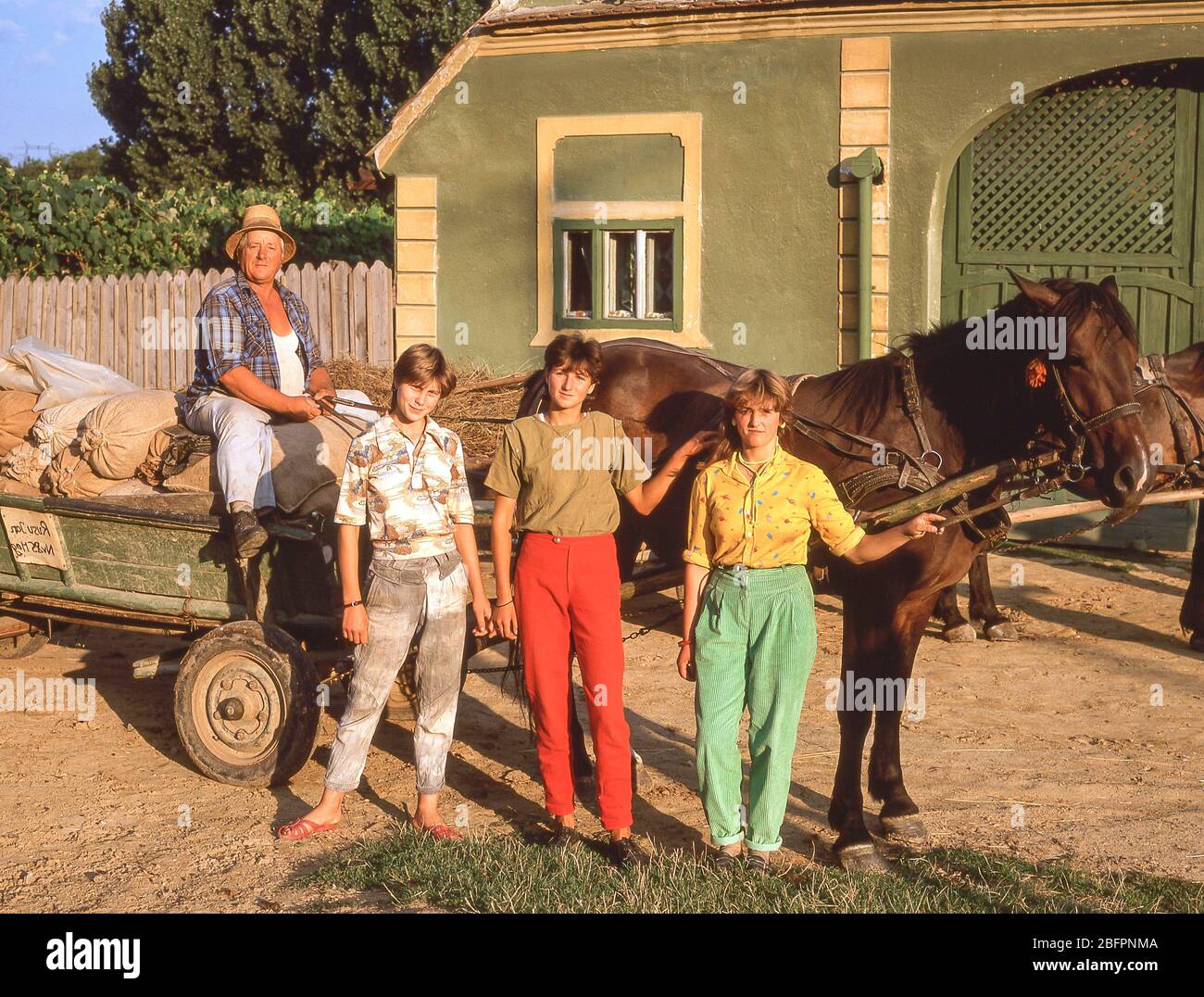 Local girls and farmer with horse buggy in countryside, near Bran, Brasov County, Romania Stock Photo
