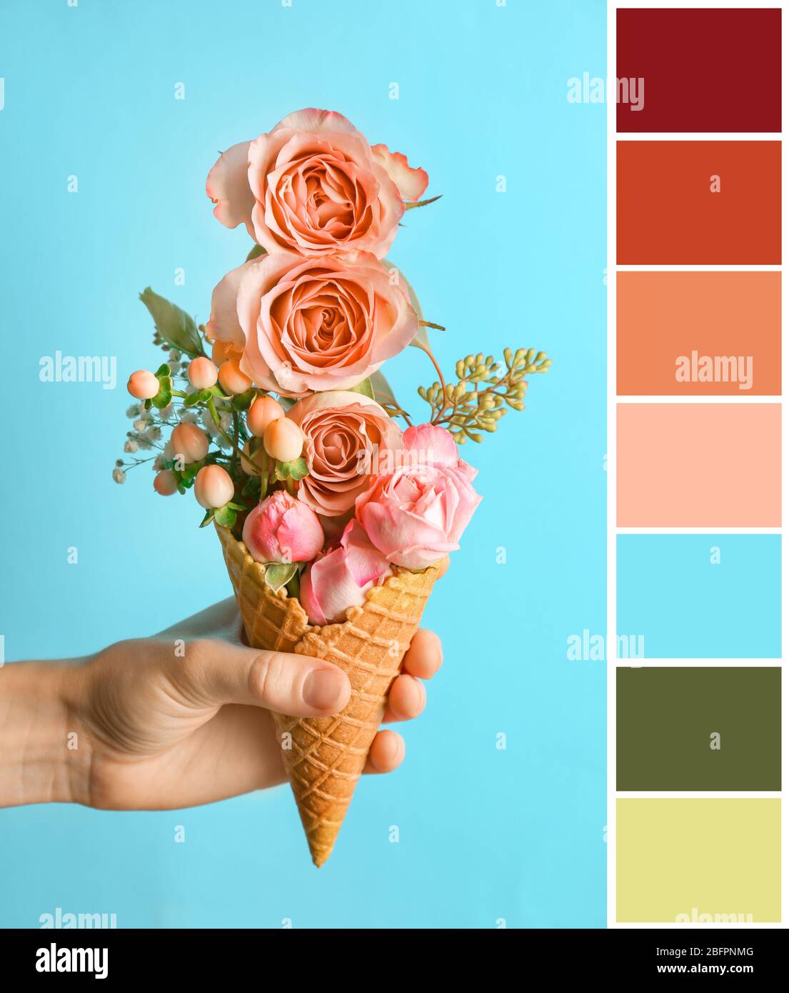 Palette with salmon color and woman holding waffle cone with floral composition on blue background Stock Photo