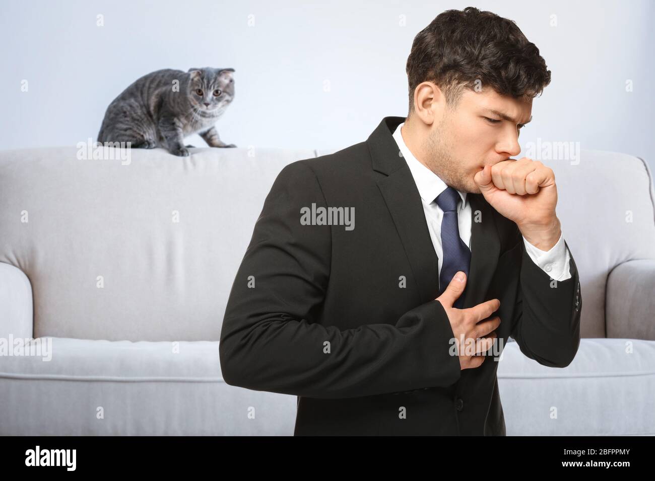 Ill man suffering from cough and pet on background. Concept of