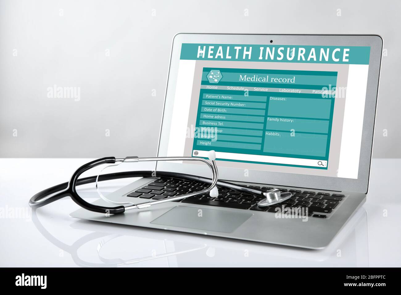 Laptop and stethoscope on light background. Health insurance concept ...