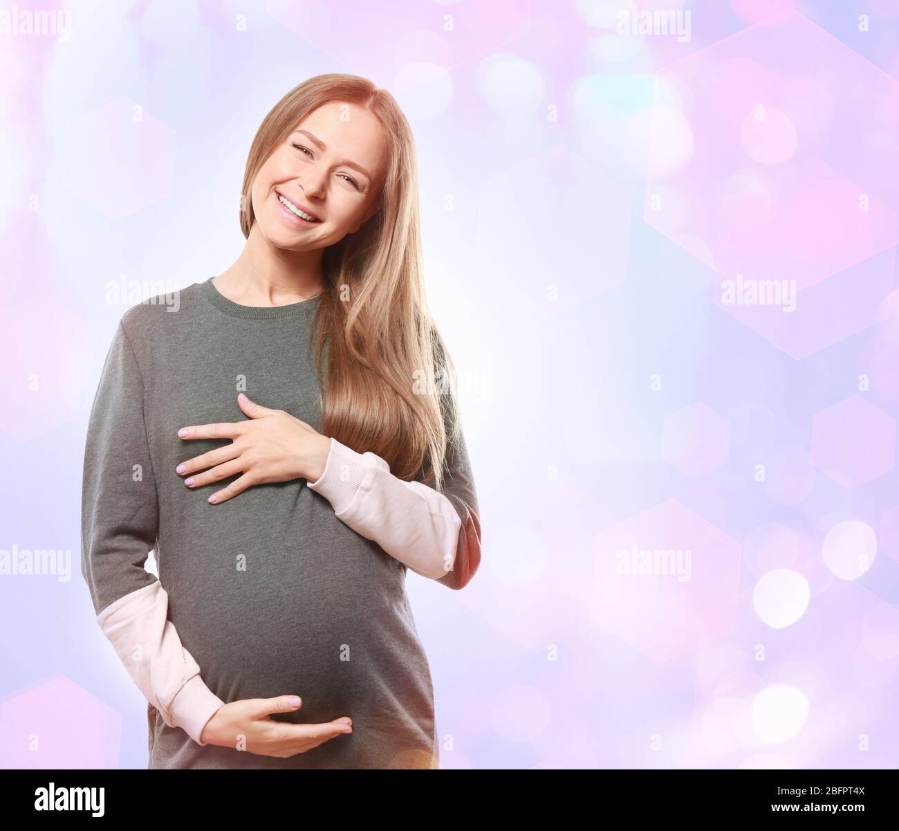 Pregnant woman on Christmas lights background Stock Photo - Alamy