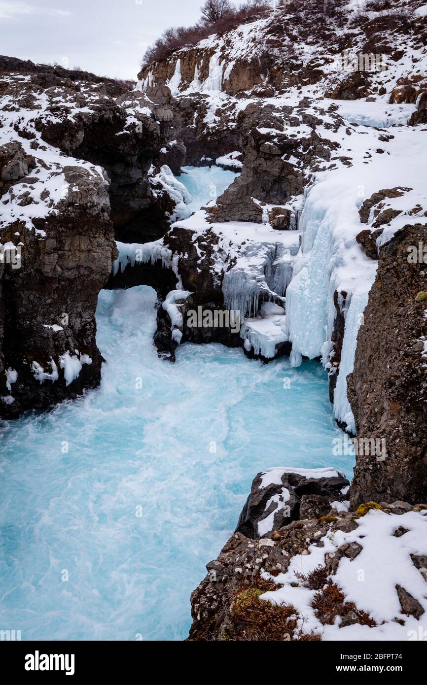 Barnafoss (Bjarnafoss) waterfall near Hraunfossar on the glacier-fed Hvita River in West Iceland in winter Stock Photo