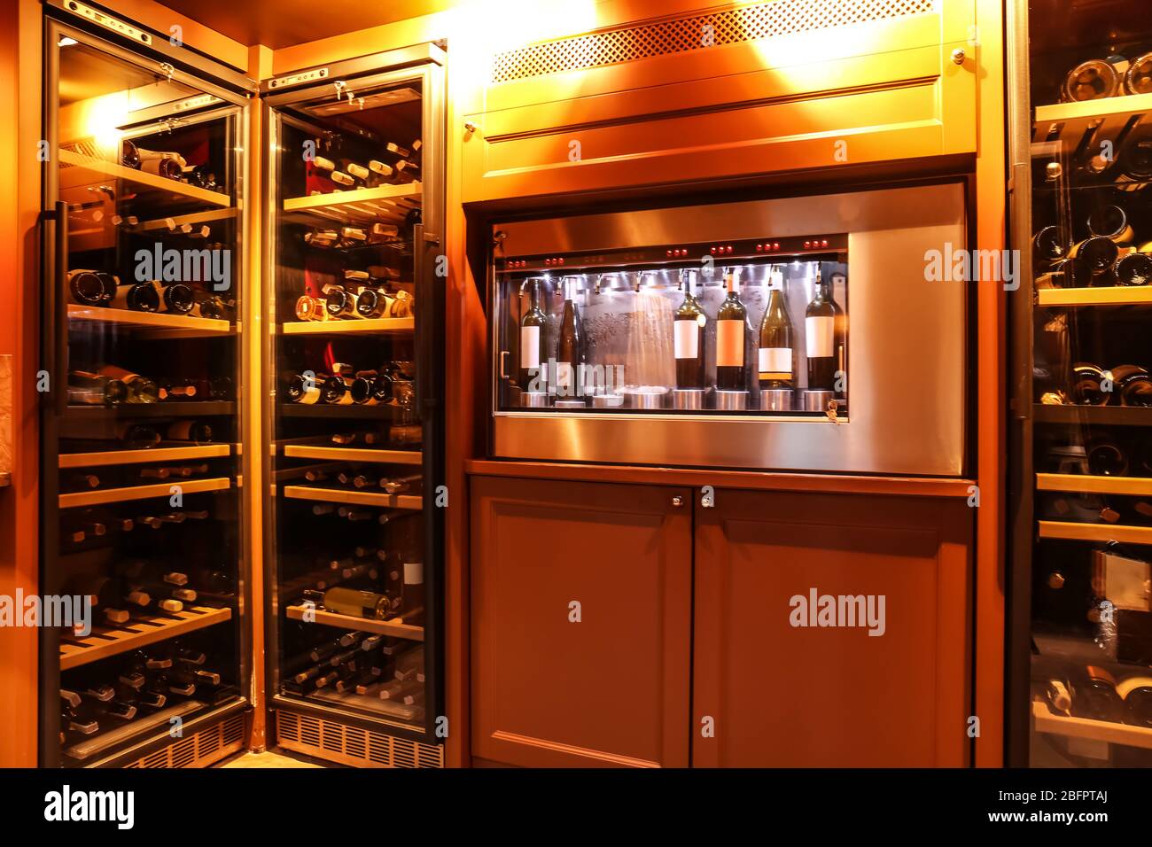 Dispenser and refrigerators with bottles of wine in cellar Stock Photo