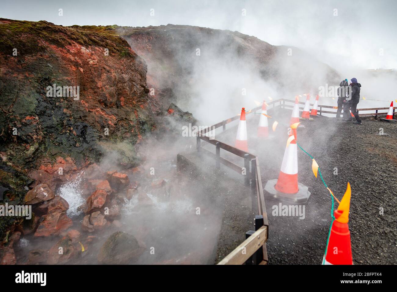 Traffic cones warn tourists away from the boiling waters of Deildartunguhver thermal spring in winter, Borgarnes, Iceland, Polar Regions Stock Photo