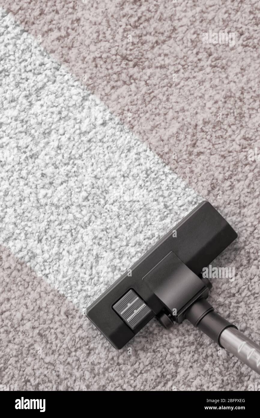 Vacuum cleaner removing dirt from carpet Stock Photo Alamy