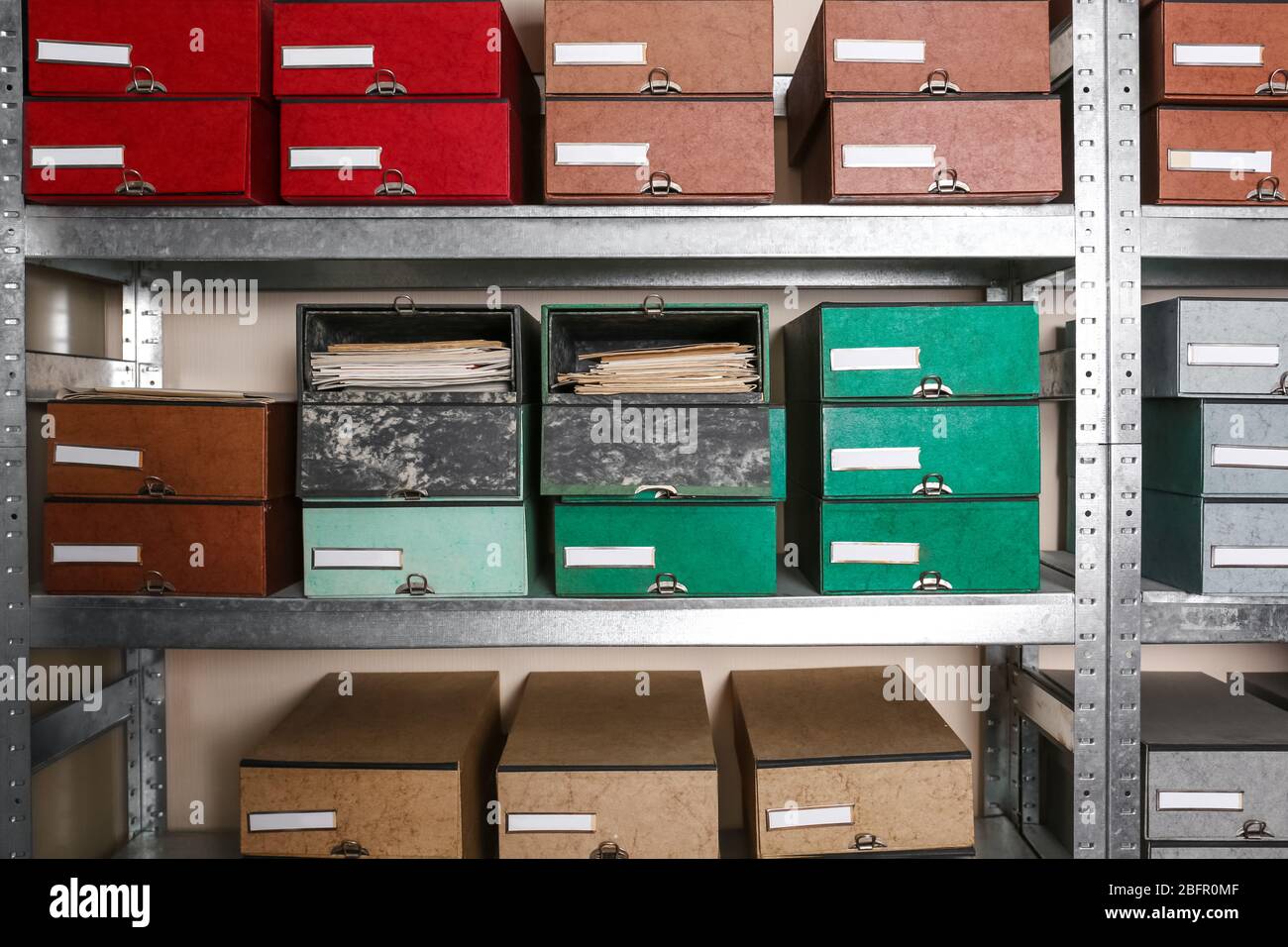 Cardboard boxes with documents on shelving unit in archive Stock Photo