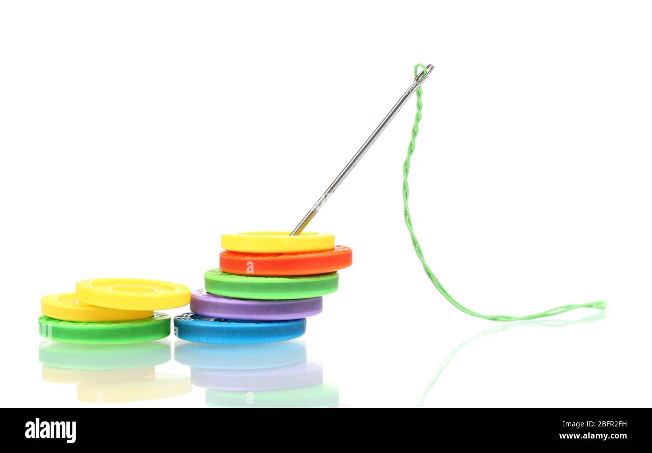 bright sewing buttons and needle with thread isolated on white Stock ...