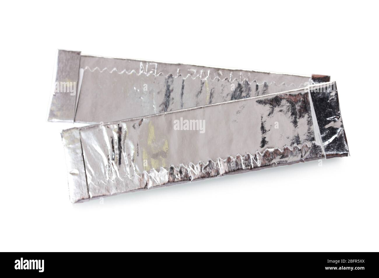 chewing tobacco wrapped in gum two chewing gums wrapped in standard silver foil, isolated on white Stock  Photo