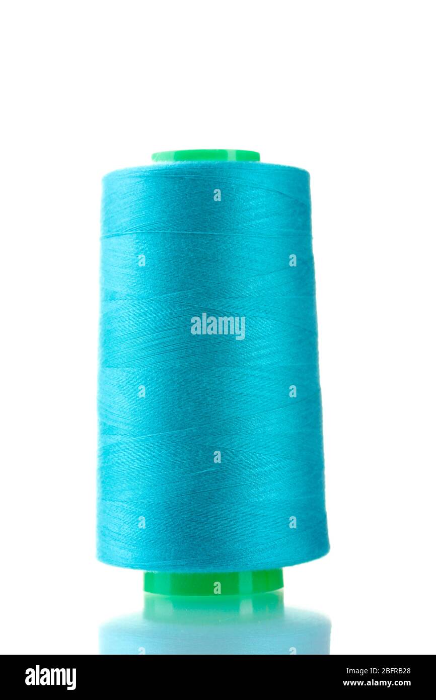 Blue bobbin thread isolated on white Stock Photo - Alamy
