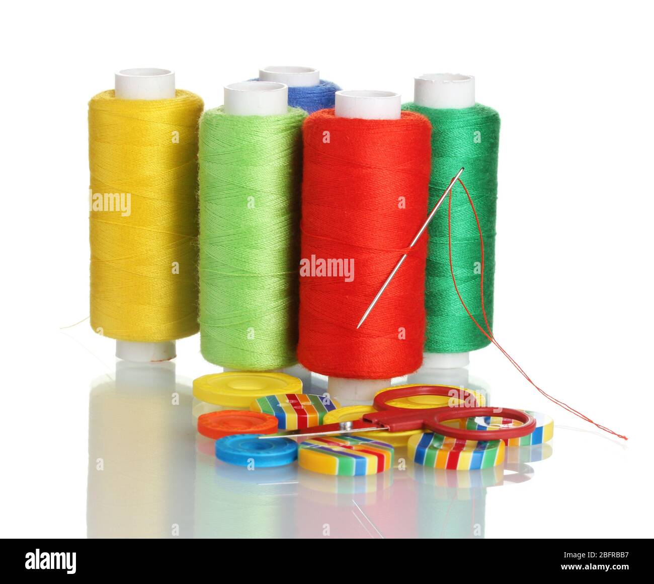 Many bobbin of thread with needle and buttons isolated on white Stock ...