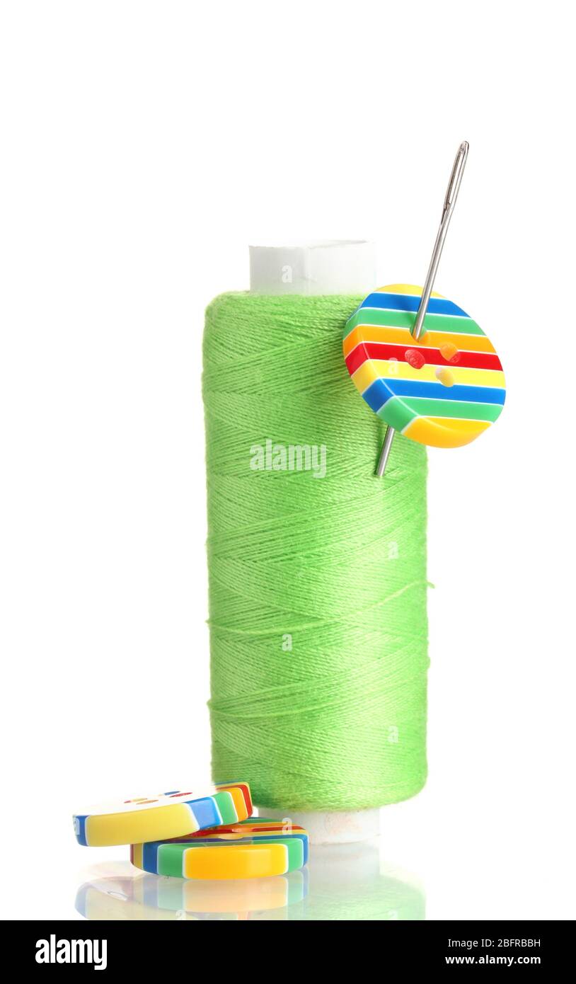 Green bobbin with needle and buttons isolated on white Stock Photo - Alamy