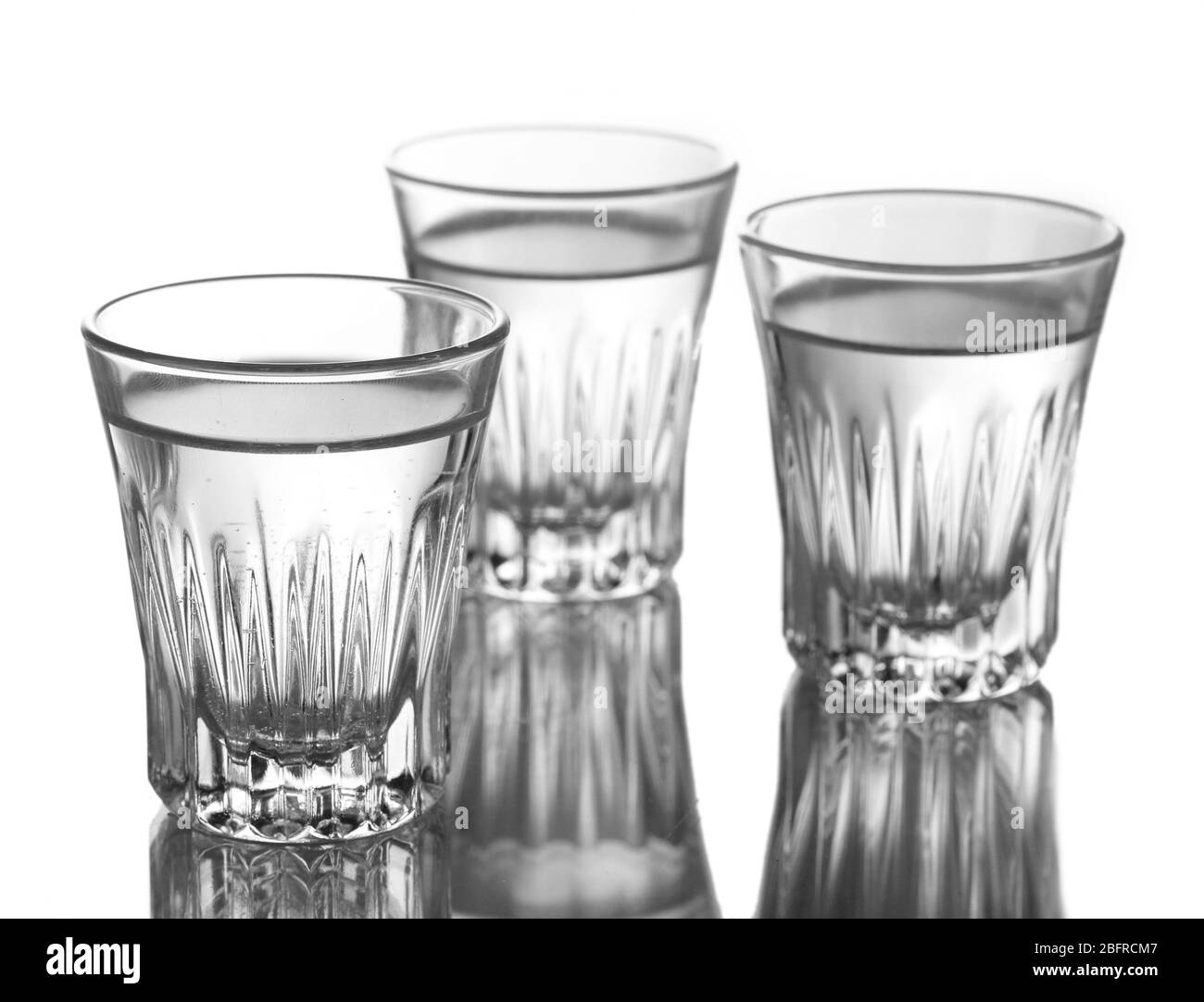 Three glass of vodka isolated on white Stock Photo