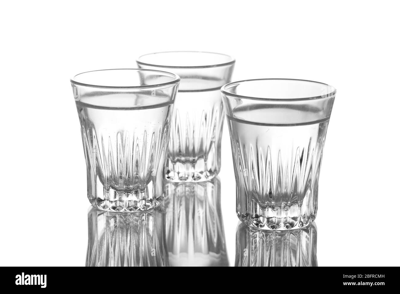 Three glass of vodka isolated on white Stock Photo