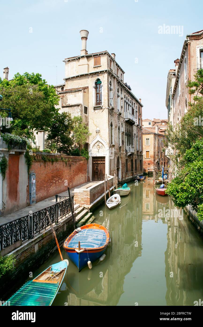 Early morning in a small side canal. Boats are tied and no people are about. Stock Photo