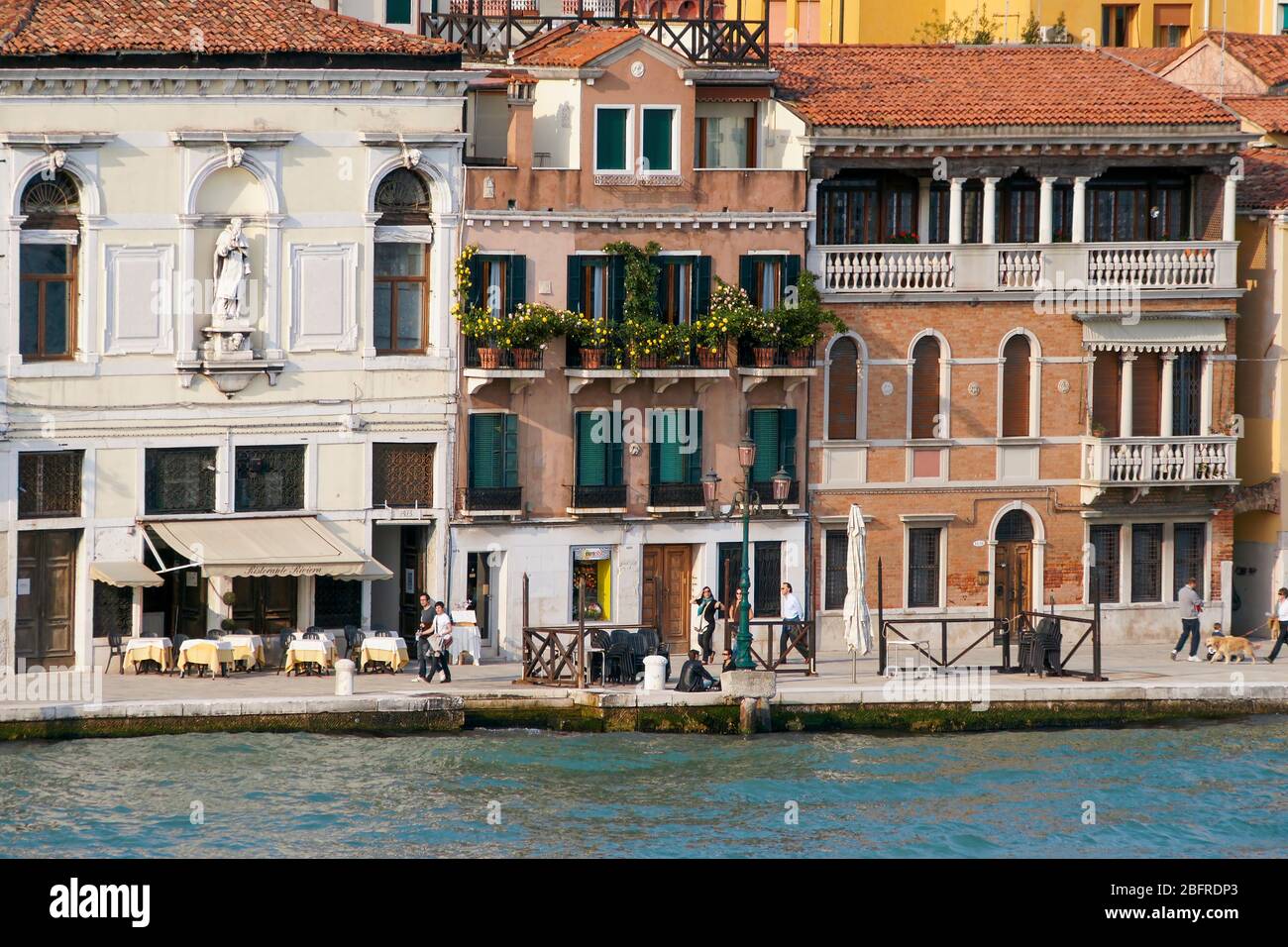 Buildings and people along the Grand Canal. Venice, Italy Stock Photo