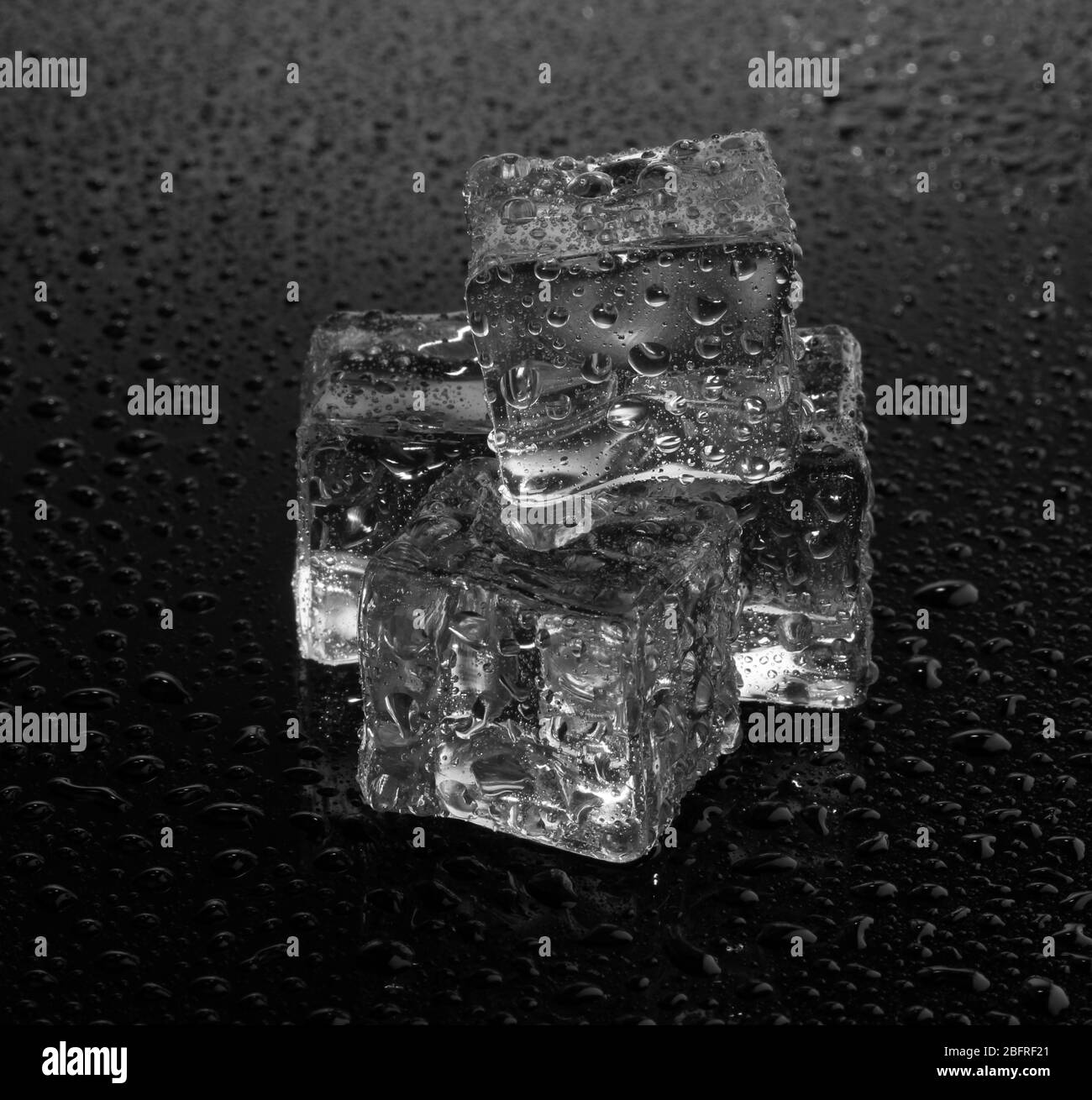 Melting ice cubes on grey background Stock Photo