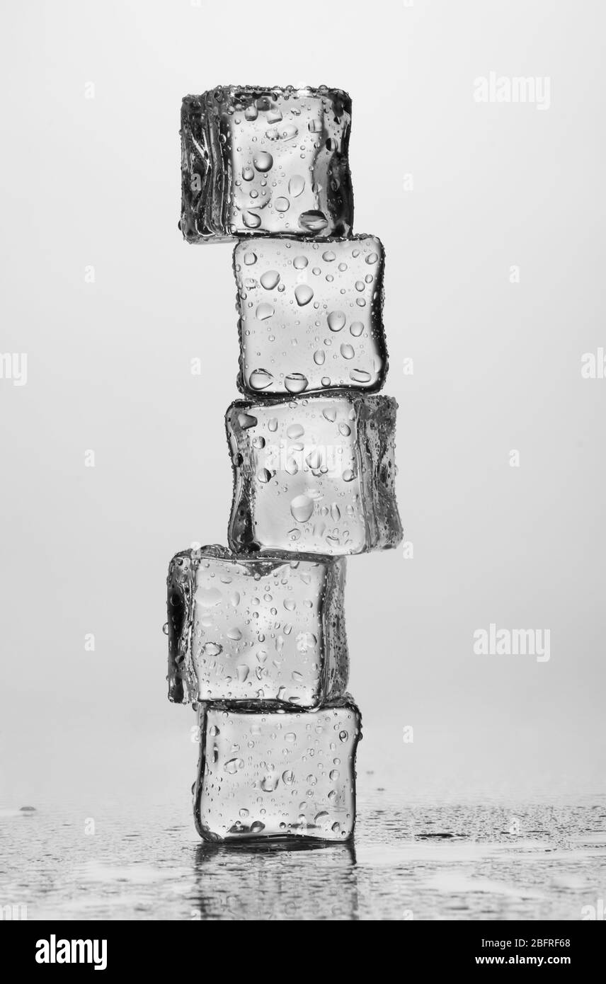 Melting ice cubes isolated on white Stock Photo - Alamy