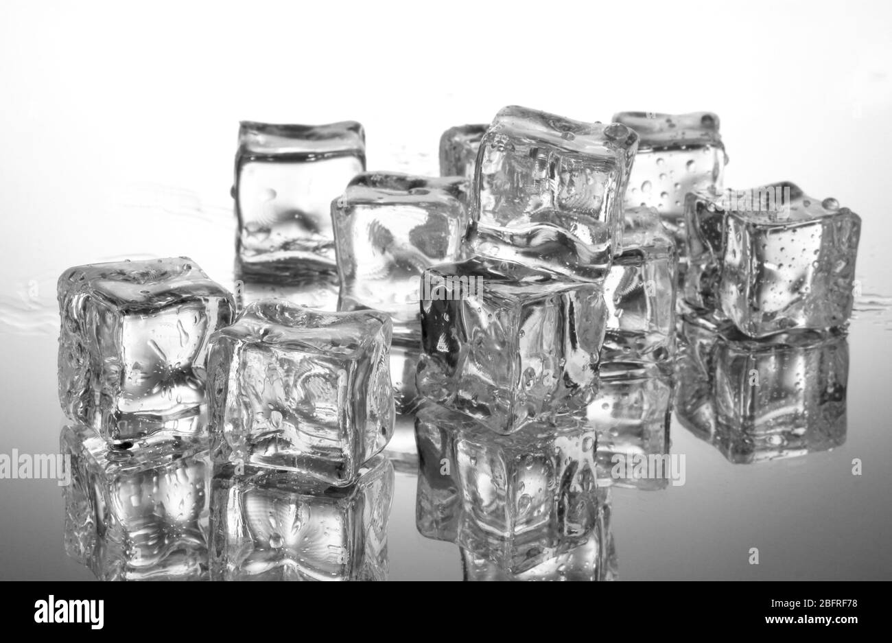 Melting ice cubes on grey background Stock Photo