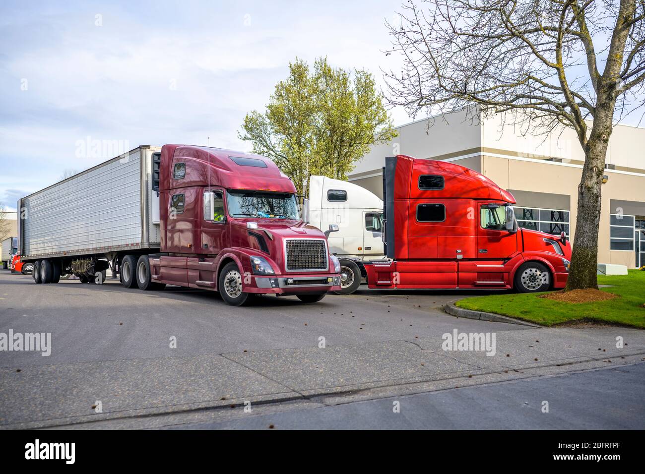 Different colors Big Rigs long haul diesel Semi Trucks congestion with ...