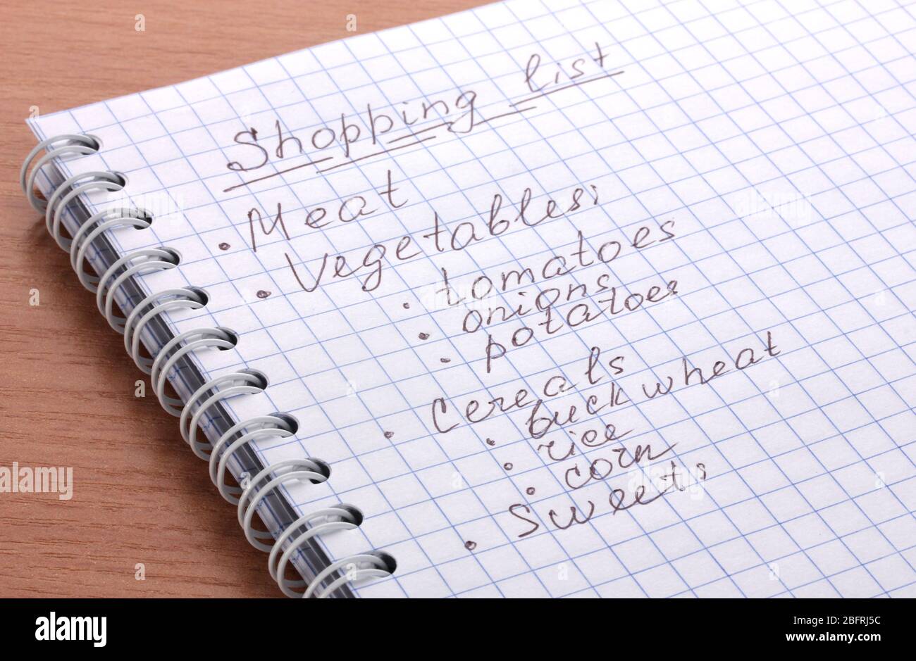 Shoping list on wooden table Stock Photo