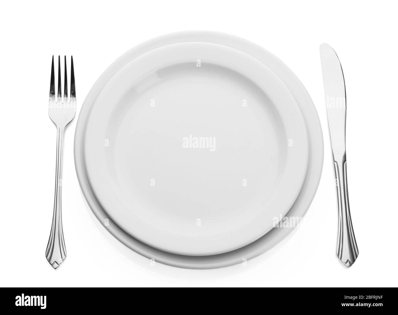 White empty plate with fork and knife isolated on white Stock Photo - Alamy