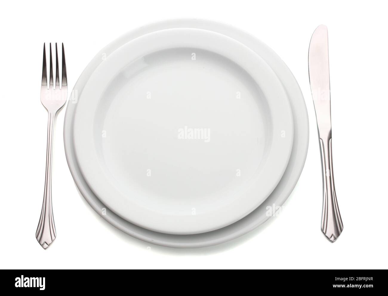 White empty plate with fork and knife isolated on white Stock Photo - Alamy