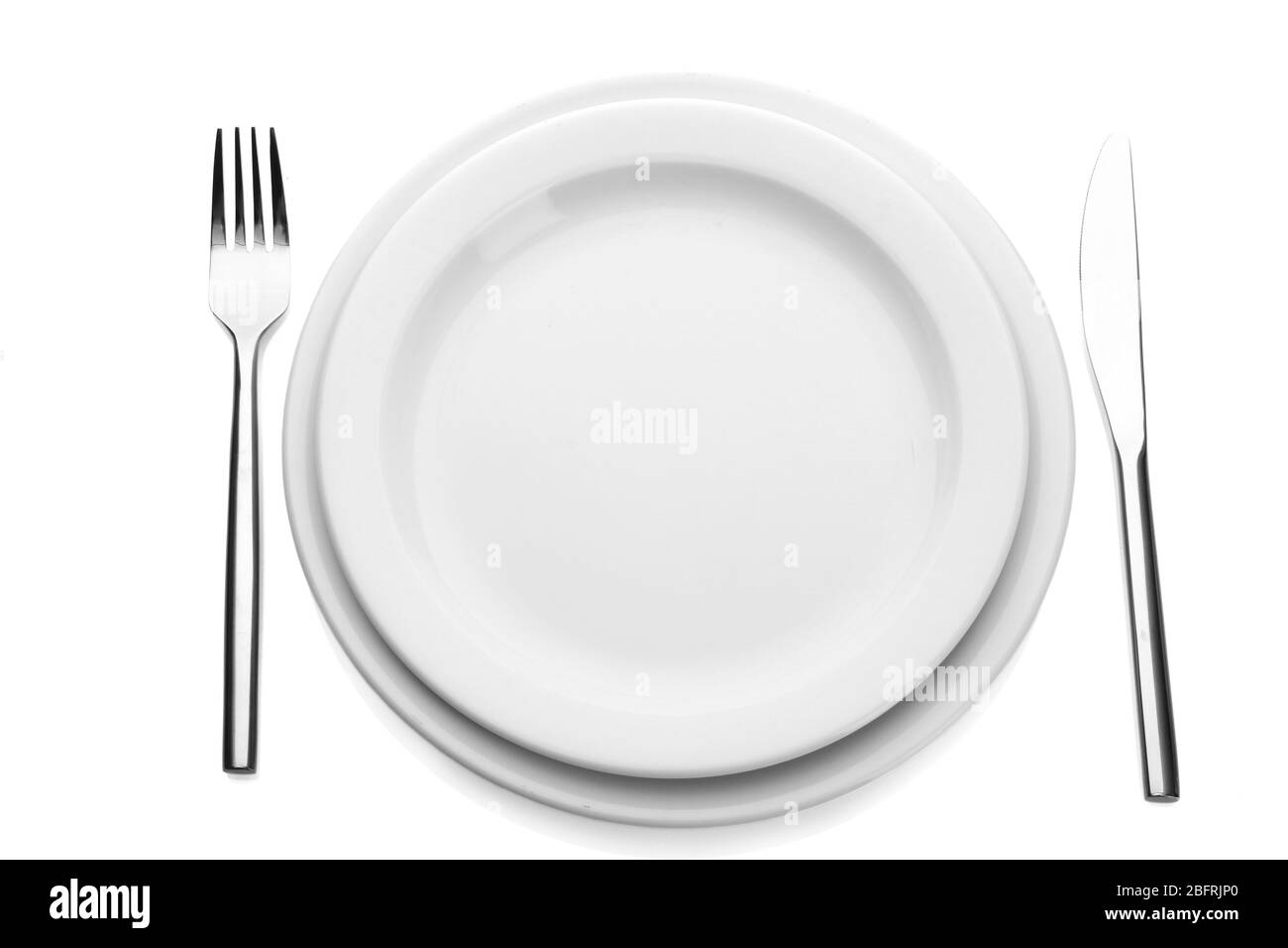 White empty plate with fork and knife isolated on white Stock Photo - Alamy