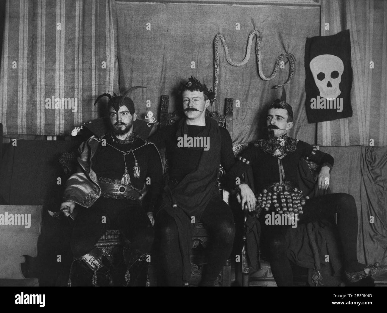 Devil Jesters three, the early 1900s. Halloween?  Mardi Gras?  Fraternity?  Holiday?  I have no idea who these people are, or where, or when.    To see my other vintage images, Search:  Prestor  vintage   odd Stock Photo