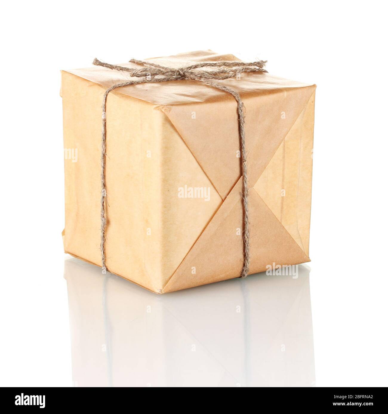 Small parcel wrapped in brown paper tied with twine isolated on white ...