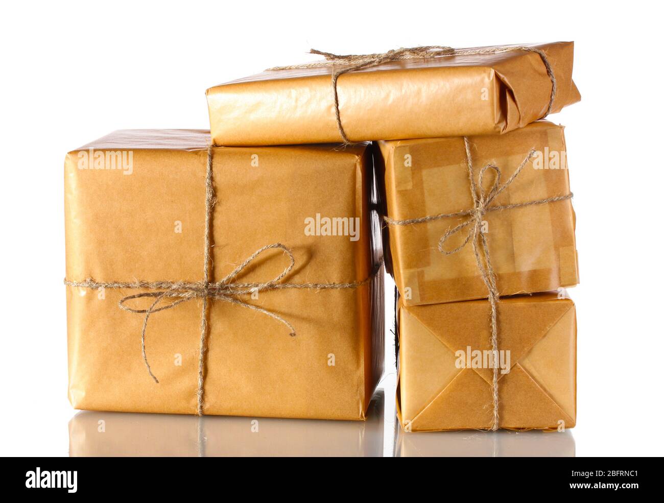 Many parcels wrapped in brown paper tied with twine isolated on white ...