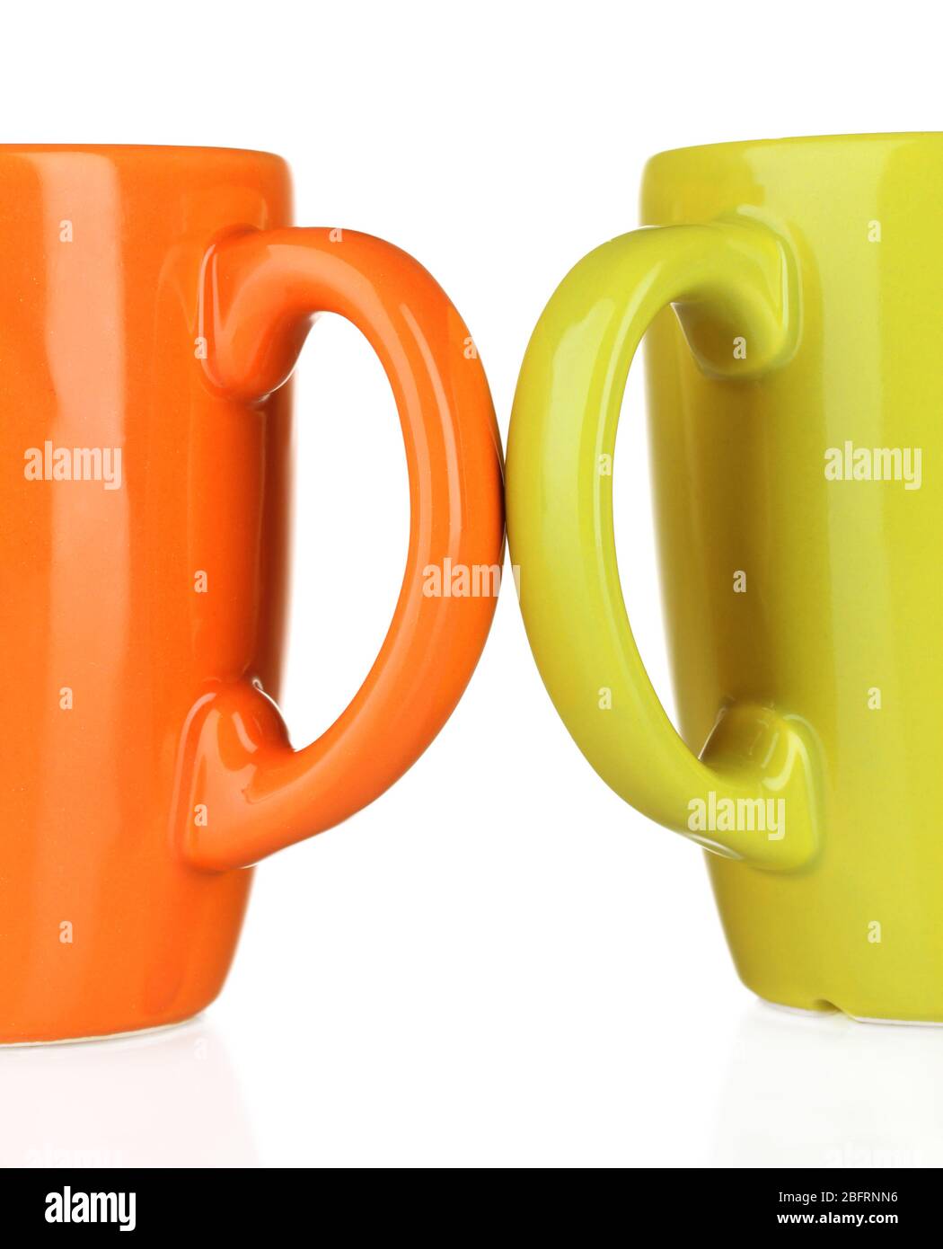 Two colored cups handles close-up isolated on white Stock Photo