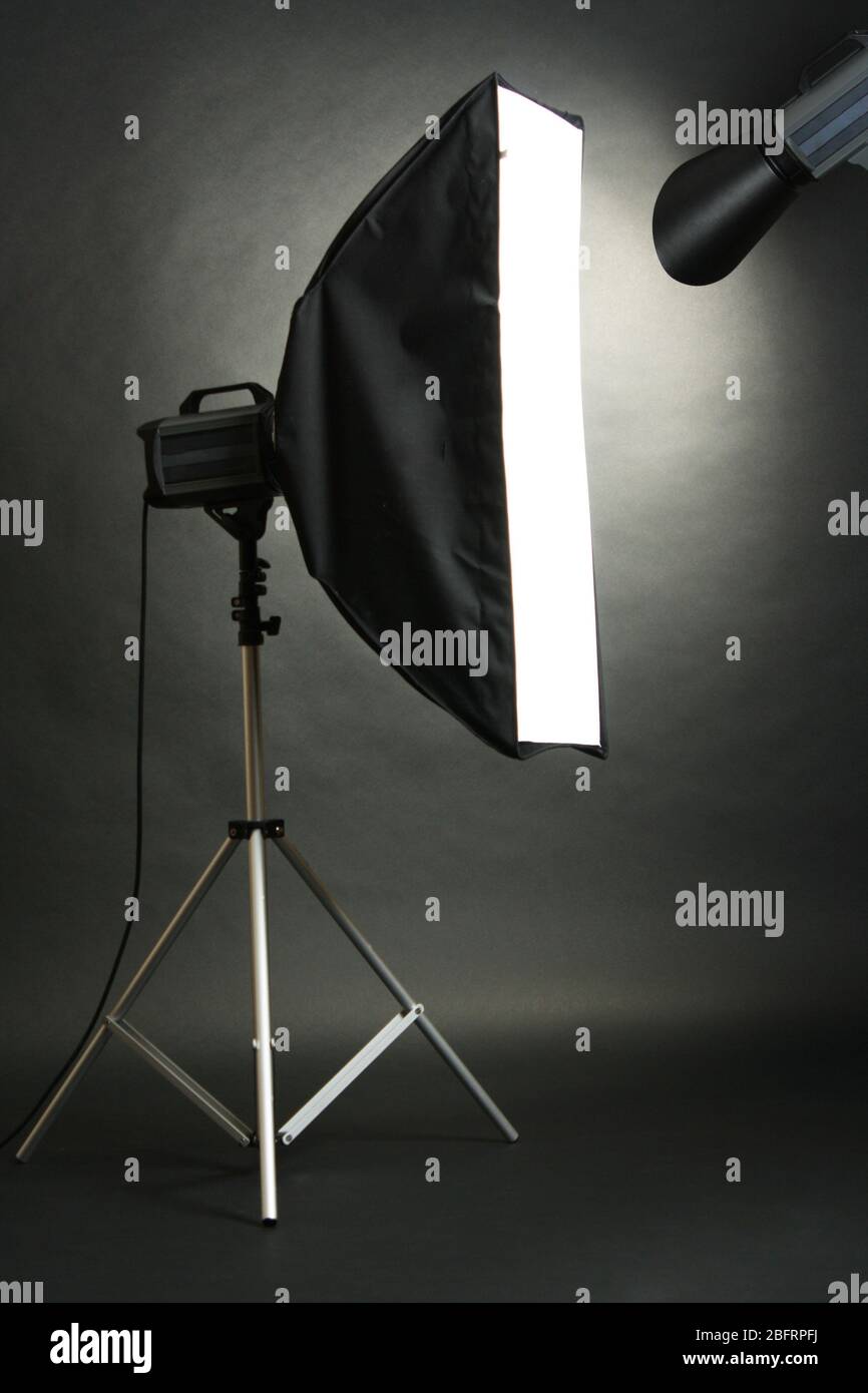 Studio flash with soft-box on black studio background Stock Photo - Alamy