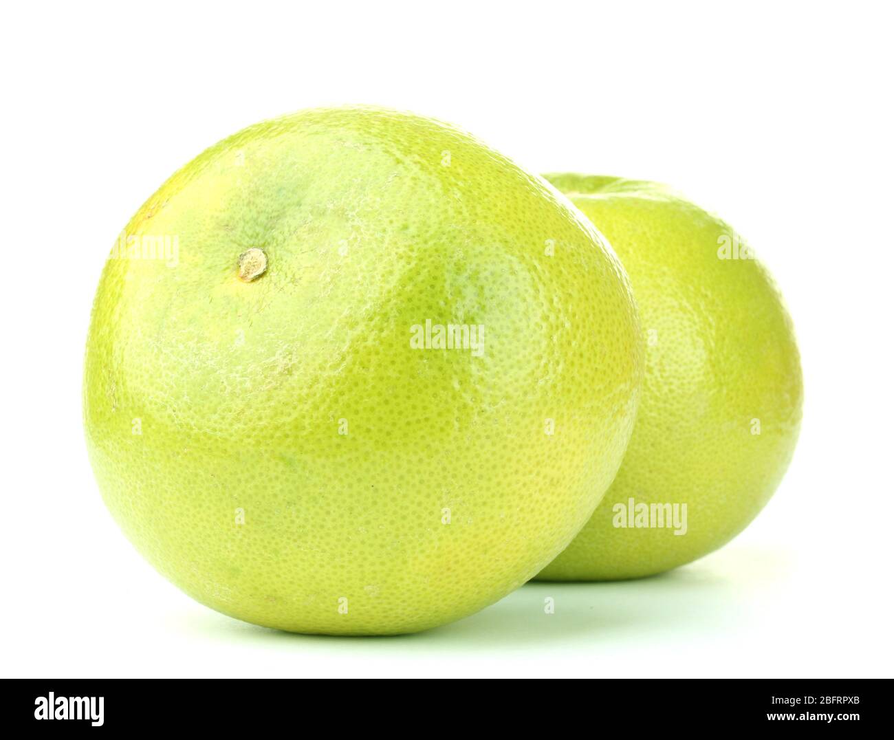 two green grapefruits isolated on white Stock Photo - Alamy