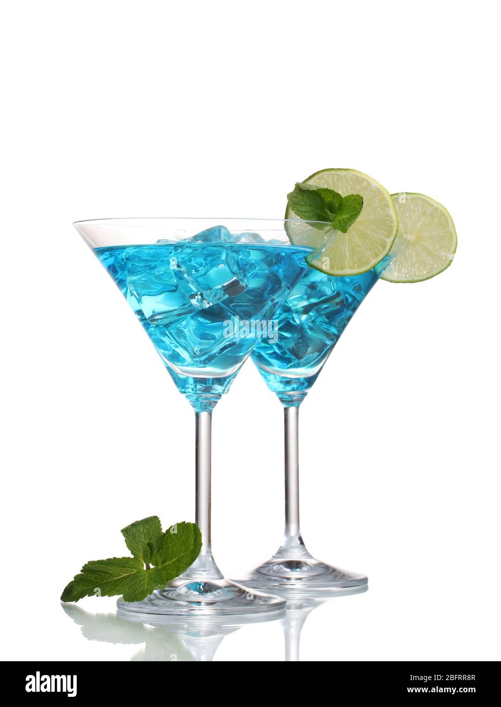 Blue cocktail in martini glasses with ice isolated on white Stock Photo ...