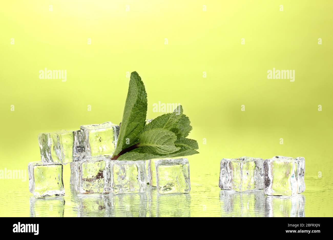 Fresh mint leaf and ice cubes with droplets on green background Stock ...