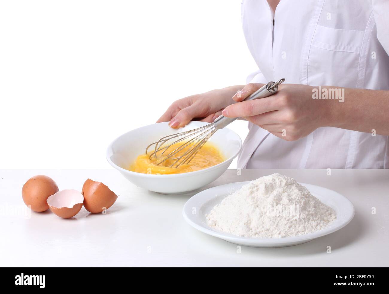Female hands mixing eggs in bowl isolated on white Stock Photo Alamy