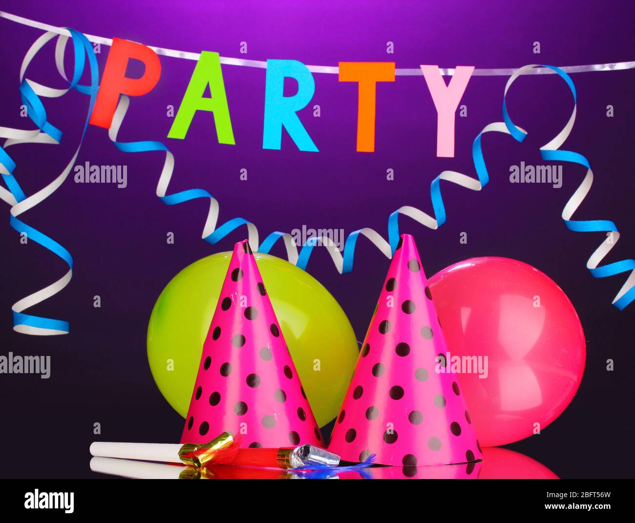 Party items on purple background Stock Photo Alamy