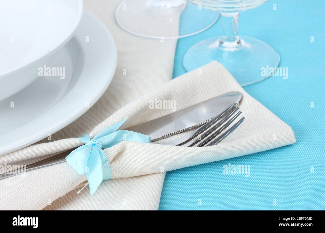 Table setting with fork, knife, plates, and napkin Stock Photo - Alamy